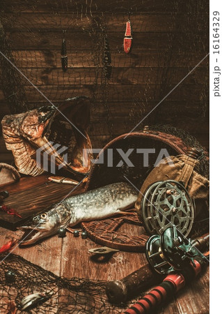 Fishing Tools and Fresh Pike on a Wooden Table