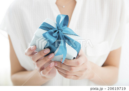 A Young Woman Giving A Gift Stock Photo