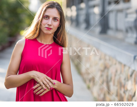 Portrait of Two Young Beautiful Fashionable Girls Posing in Street