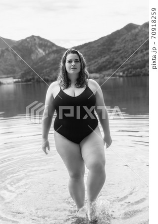 Vertical photo of plus size young woman in sexy black lingerie
