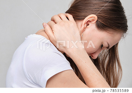 A girl in a white T-shirt massages the groin. Gynecology problems
