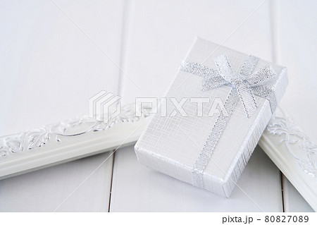 Christmas present with blue bow and silver decorations closeup