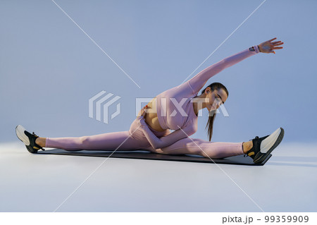 Fit Young Lady Lying on Mat with Roll on Breast during Workout