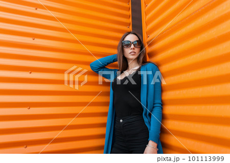 Hipster fashion young woman in bright clothes, sun glasses and